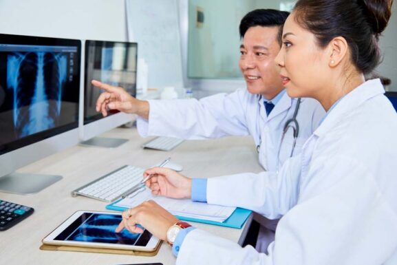 interventional radiologists discussing medical report