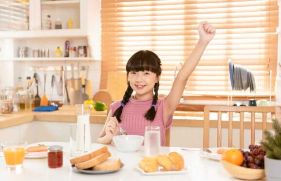 A happy girl with breakfast